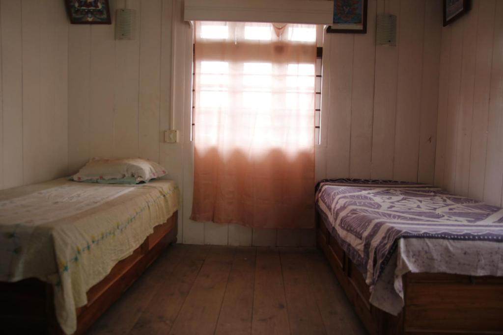 Letto o letti in una camera di Vamoose Gomethang Homestay