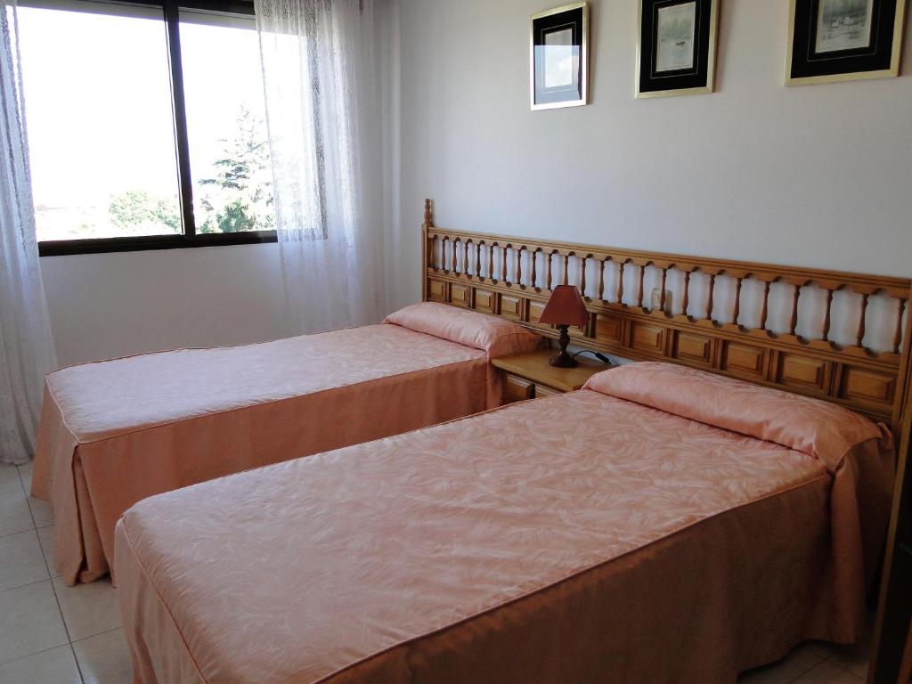 Posteľ alebo postele v izbe v ubytovaní Apartamentos Blanco