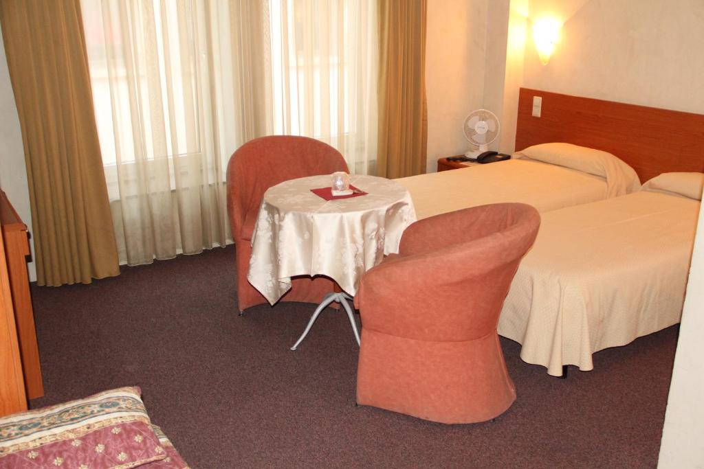 Postel nebo postele na pokoji v ubytování Auberge Gaglioti