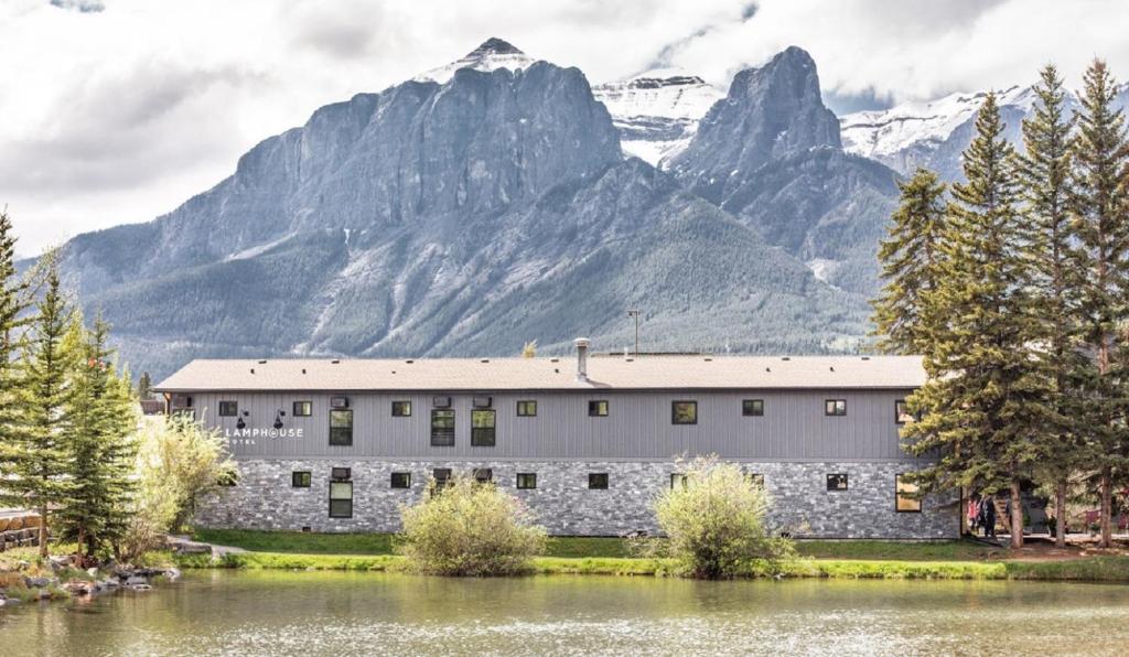 a large building with a mountain range in front of it at Lamphouse Hotel in Canmore