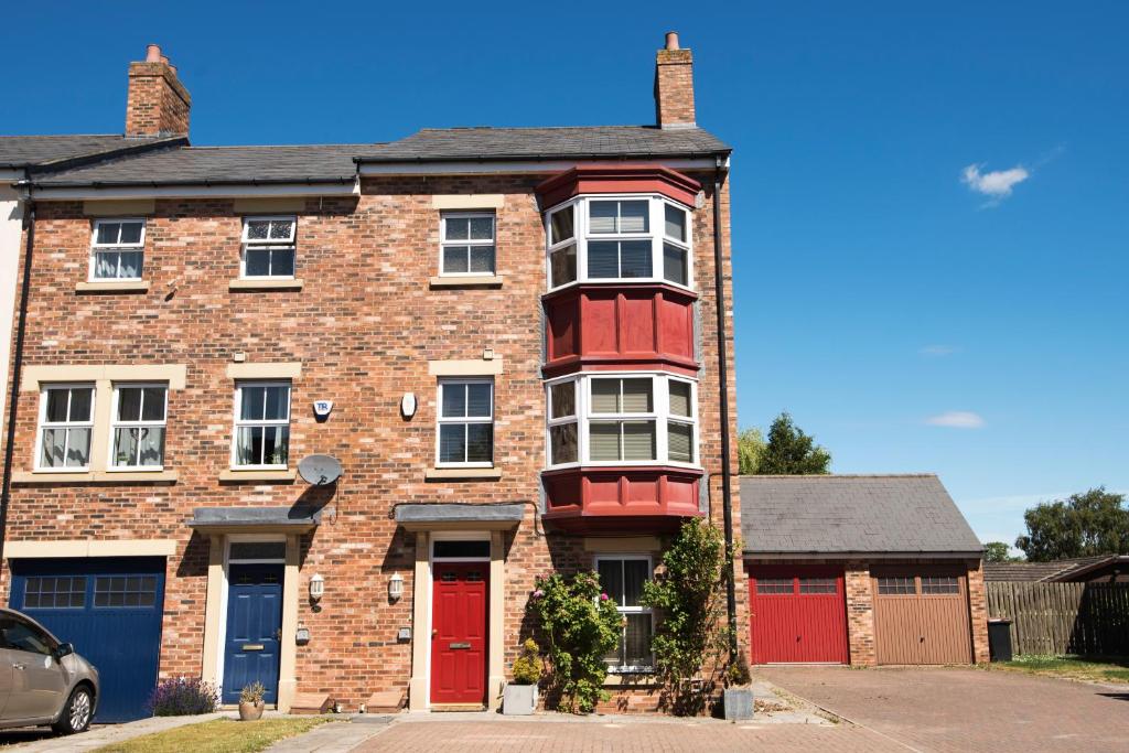 a red brick house with a red door at Kirkwood Drive in Durham