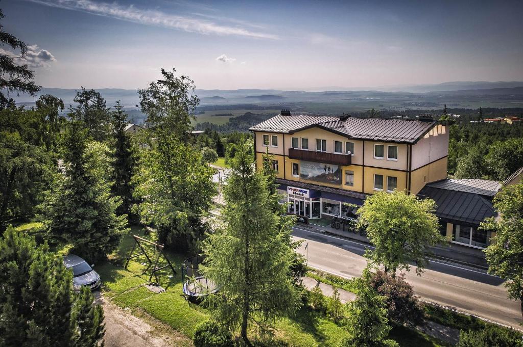 an overhead view of a house with a road and trees at Vyhliadka Galfy in Starý Smokovec