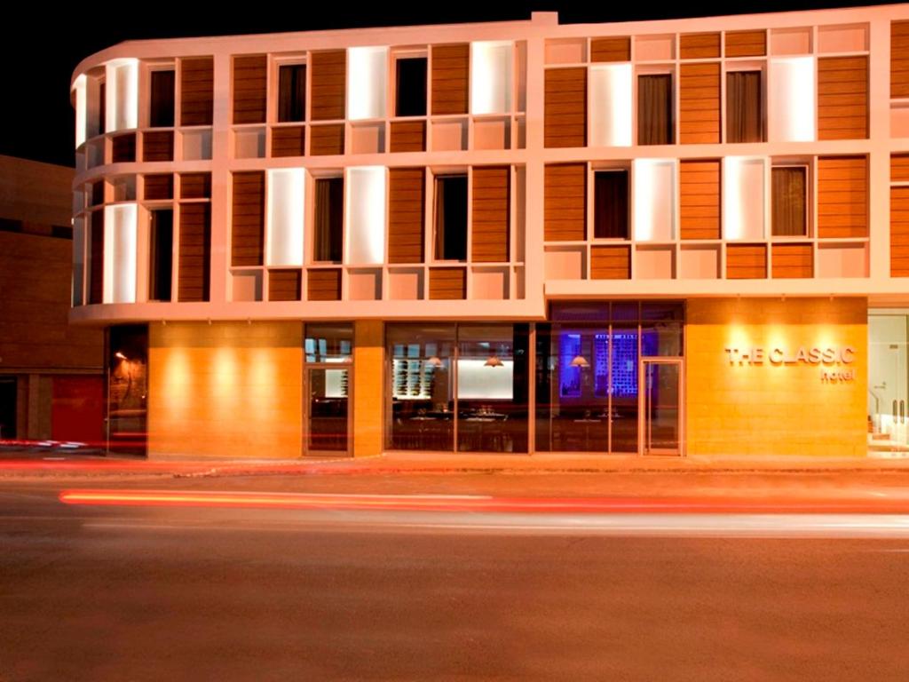 a building on a city street at night at The Classic Hotel in Nicosia