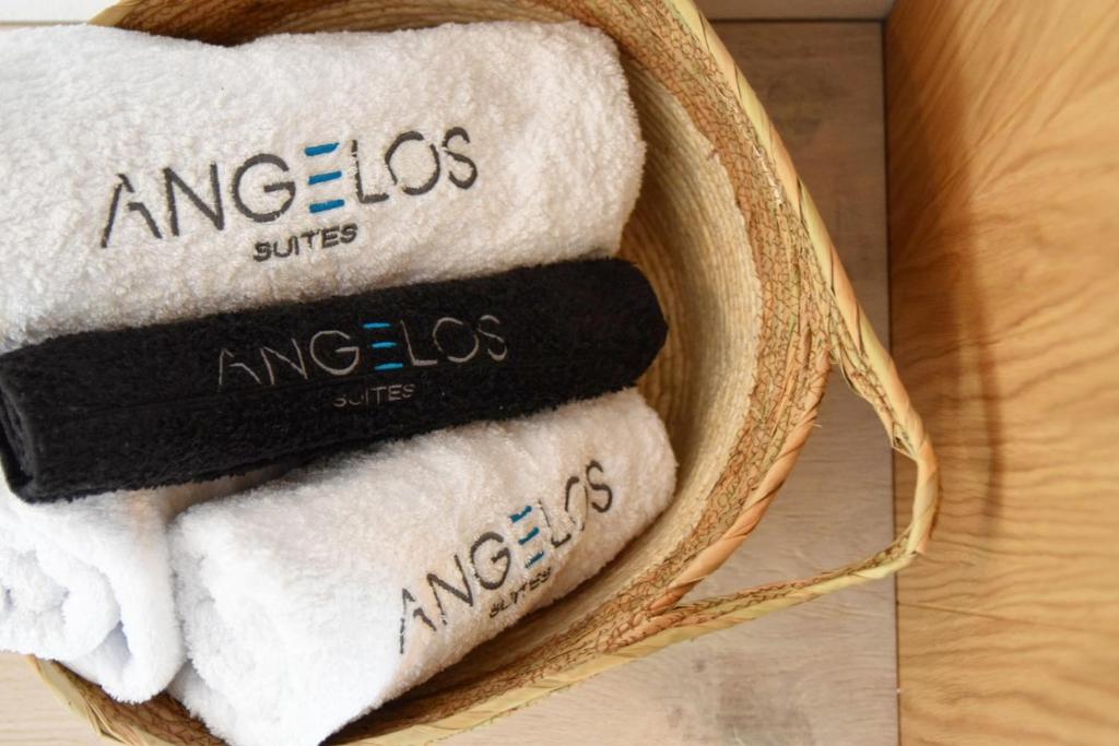 a basket filled with towels on a table at Angelos Boutique Suites in Patitiri