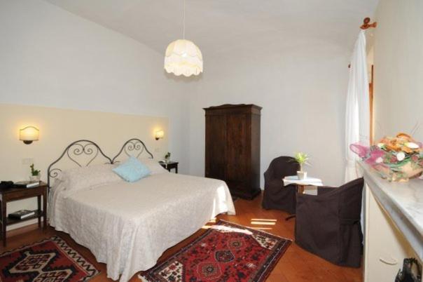 Postel nebo postele na pokoji v ubytování Albergo Duomo