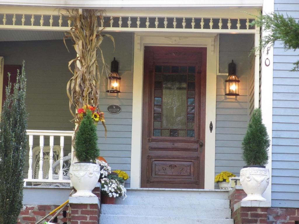 a front door of a house with flowers on the steps at Adair Manor Bed & Breakfast in Adairsville
