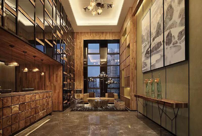 a lobby with a table and chairs in a building at Bloom Boutique Hotel in Chongqing