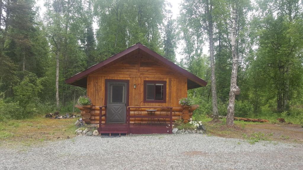 a small cabin in the middle of a forest at Talkeetna Fireweed Cabins in Talkeetna