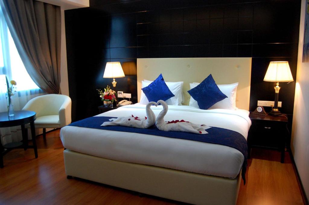 Tempat tidur dalam kamar di The Olive Hotel, Juffair