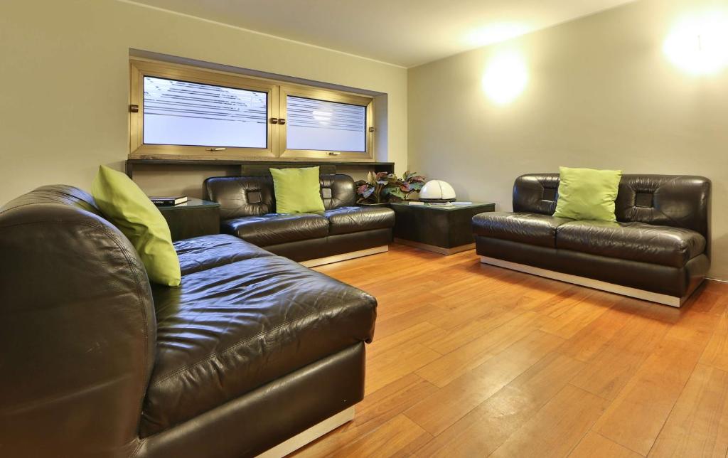 a living room with leather couches and yellow pillows at Hotel Astoria Sure Hotel Collection By Best Western in Milan