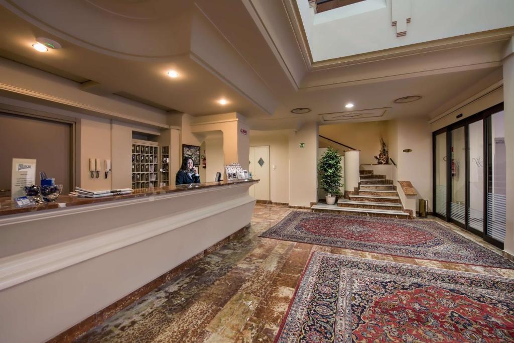 a lobby of a building with a person standing at a counter at Best Western Hotel Stella d'Italia in Marsala