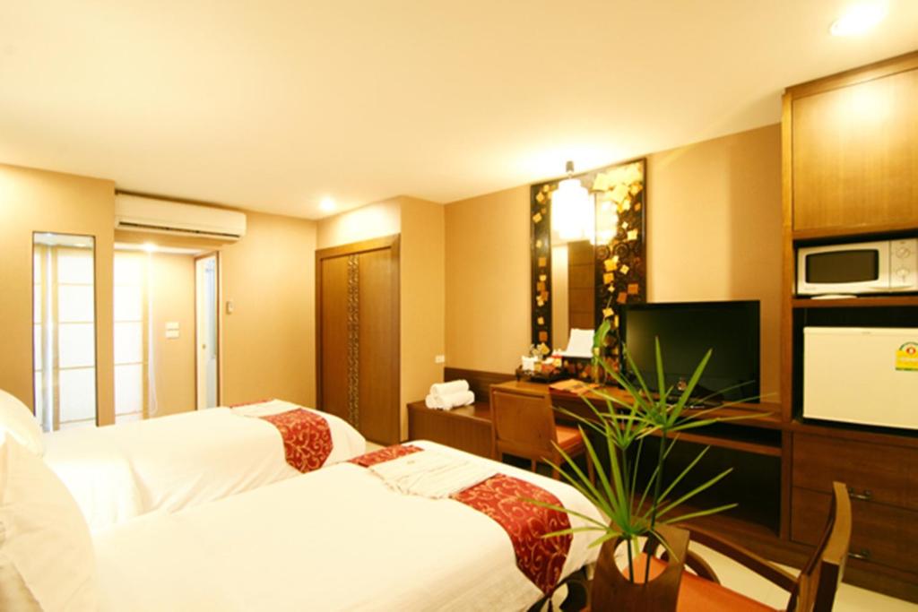 Postel nebo postele na pokoji v ubytování Mariya Boutique Hotel At Suvarnabhumi Airport