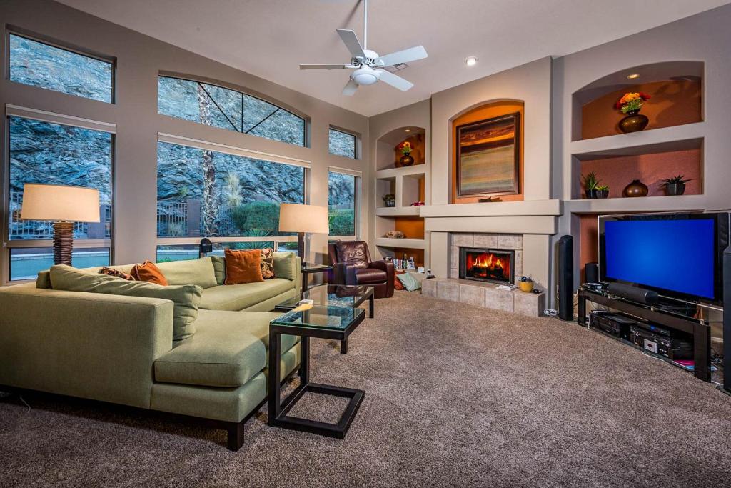 a living room with a fireplace and a tv at Desert Foothills in Phoenix