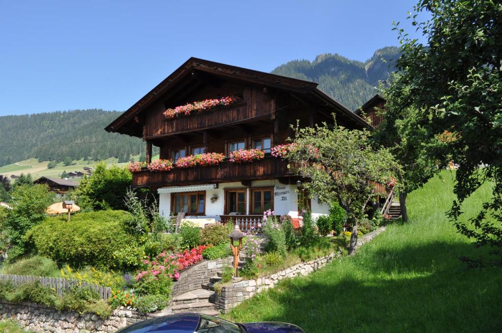 a house on a hill with flowers on it at Haus Thomas in Alpbach