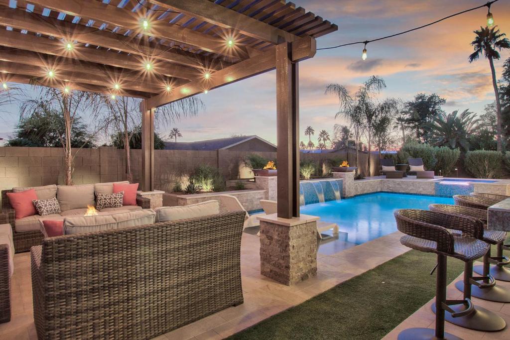 um pátio no quintal com uma piscina e uma pérgola em Villa Tranquila em Phoenix