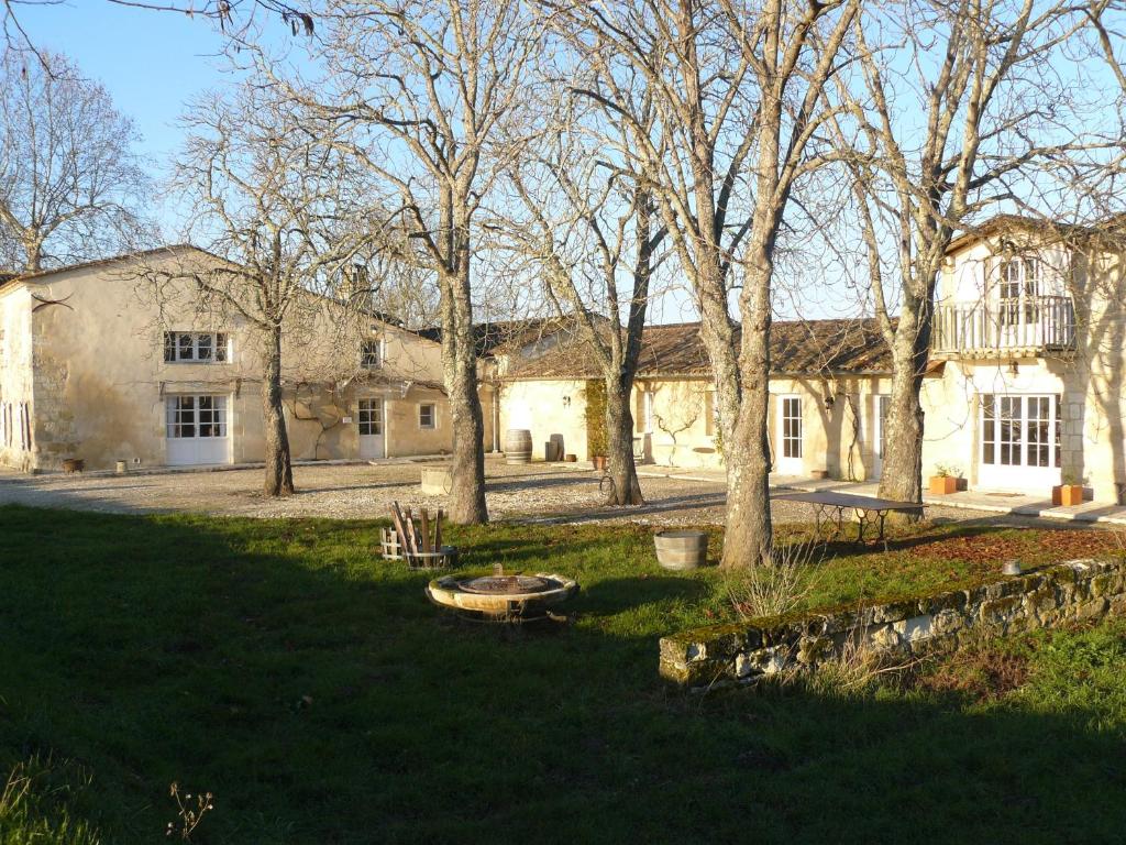 a house with a tree in front of it at Chateau de la Vieille Chapelle in Lugon et l’Ile du Carney