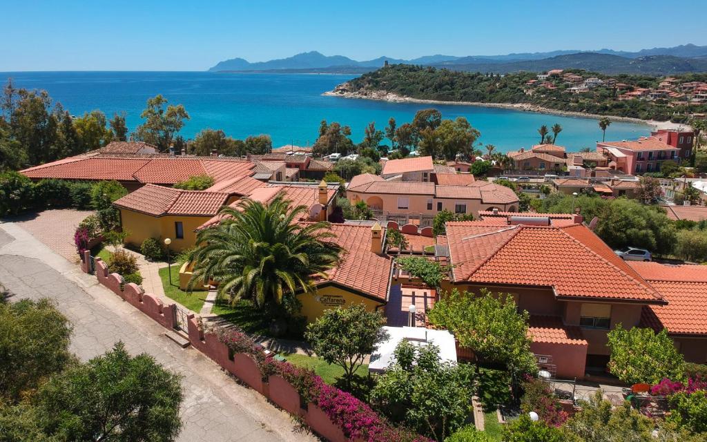 arial view of a town with houses and the water at Residence Appartamenti Caffarena in Àrbatax