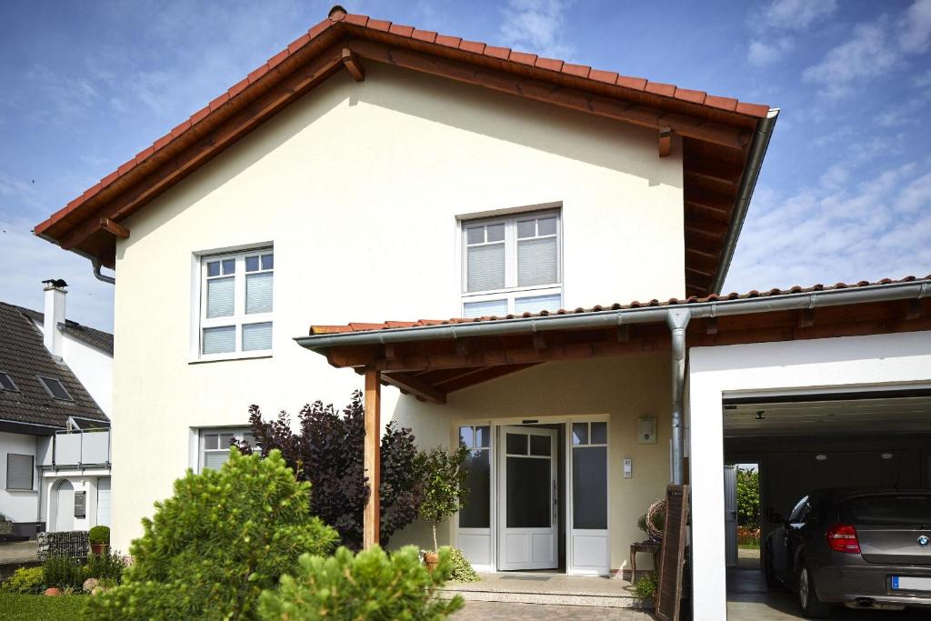 a white house with a red roof at Ferienhaus Elsa 180 qm in Rust