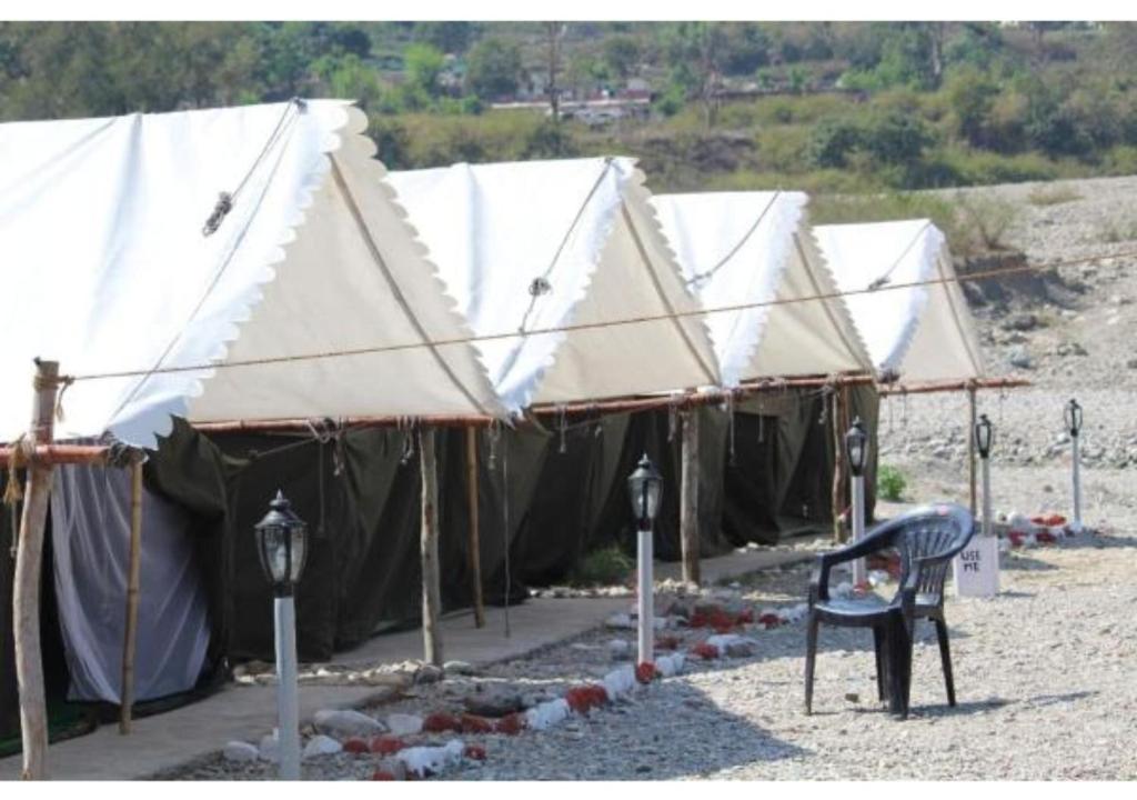 a row of tents sitting on top of a beach at The Junky Yard Camps in Rishīkesh