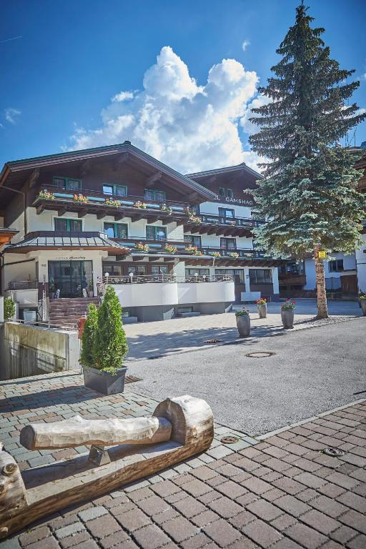 a large building with a tree in front of it at Hotel Gamshag in Saalbach-Hinterglemm