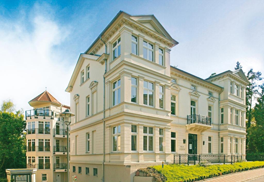 a large white building with windows at Villa Usedom in Heringsdorf