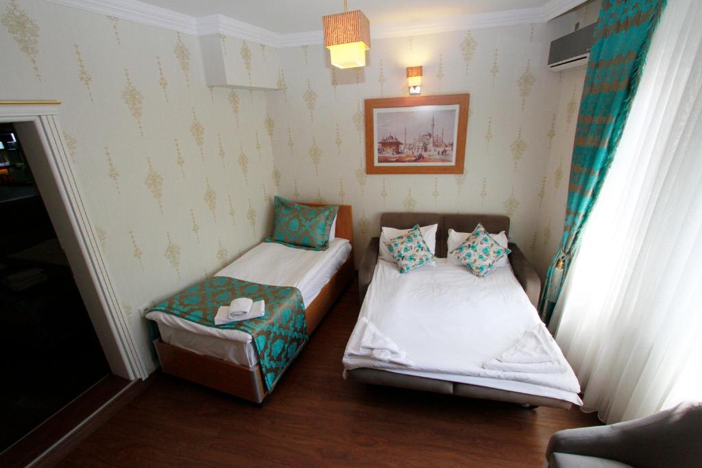 A bed or beds in a room at Agora Boutique Hotel & Bistro