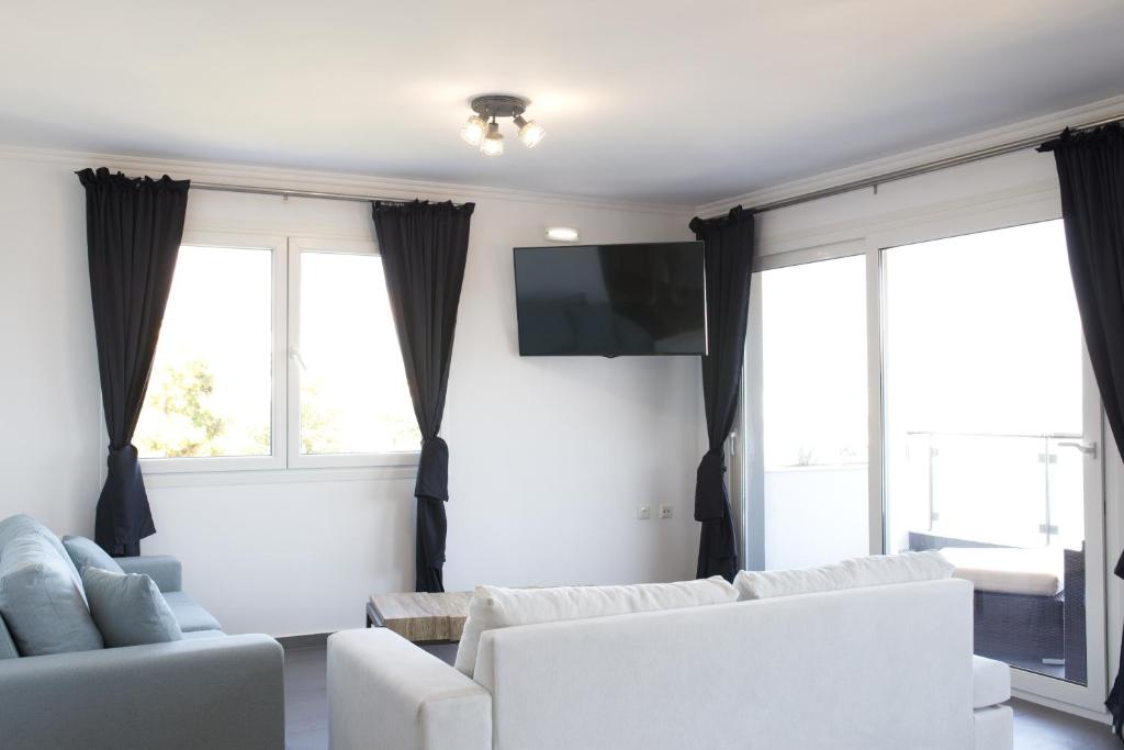 Televízia a/alebo spoločenská miestnosť v ubytovaní Blue4Aqua Apartments
