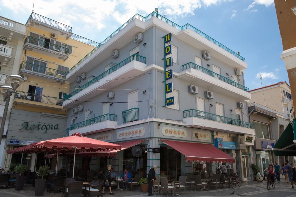 a building with a sign on the side of it at Avra Inn in Missolonghi