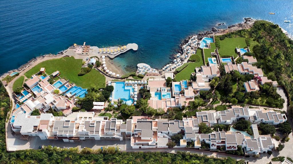 an aerial view of a resort next to the ocean at St. Nicolas Bay Resort Hotel & Villas in Agios Nikolaos
