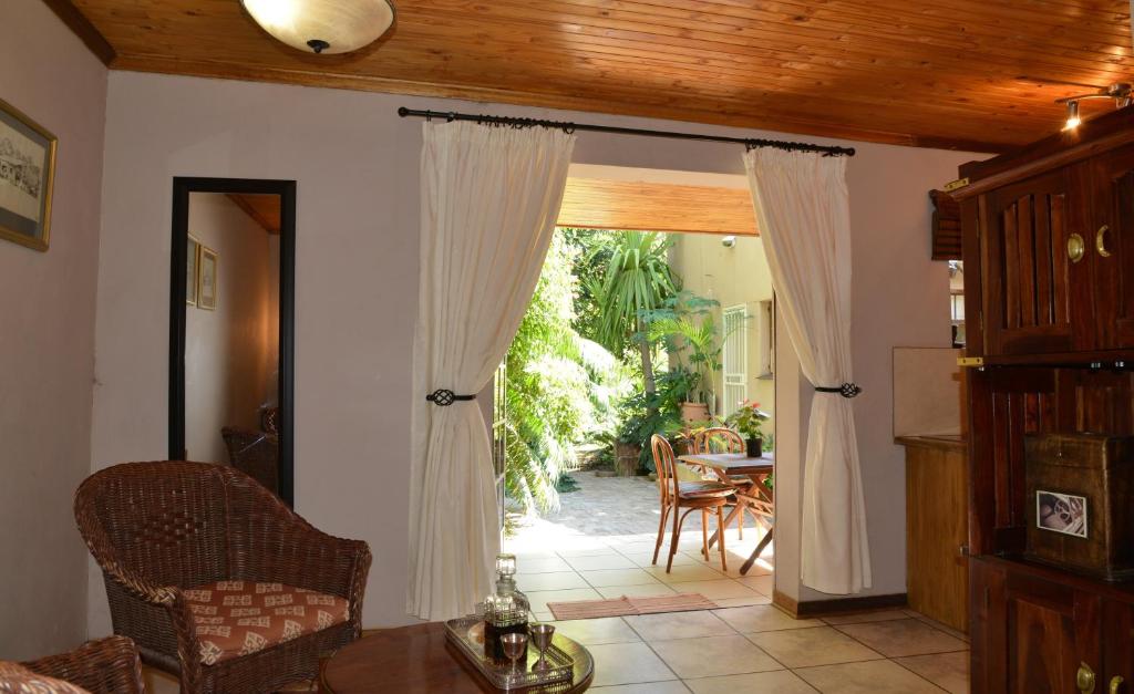 a living room with a door open to a patio at Kasane Self Catering in Kasane