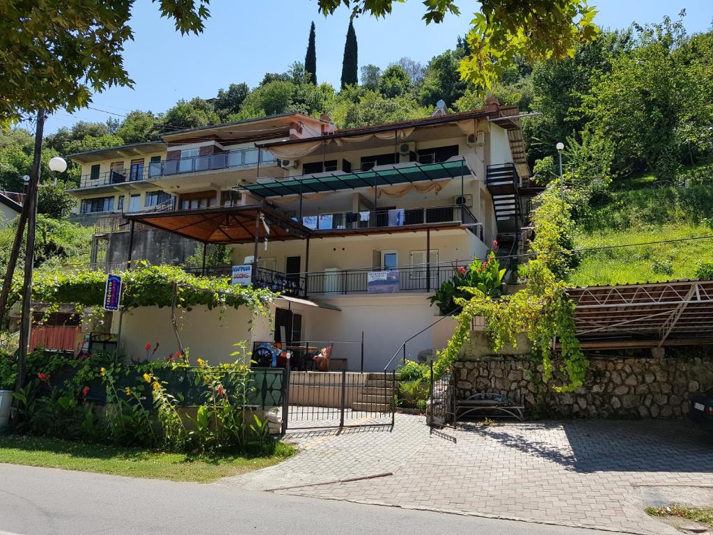 a building with a garden in front of it at Apartments President in Star Dojran