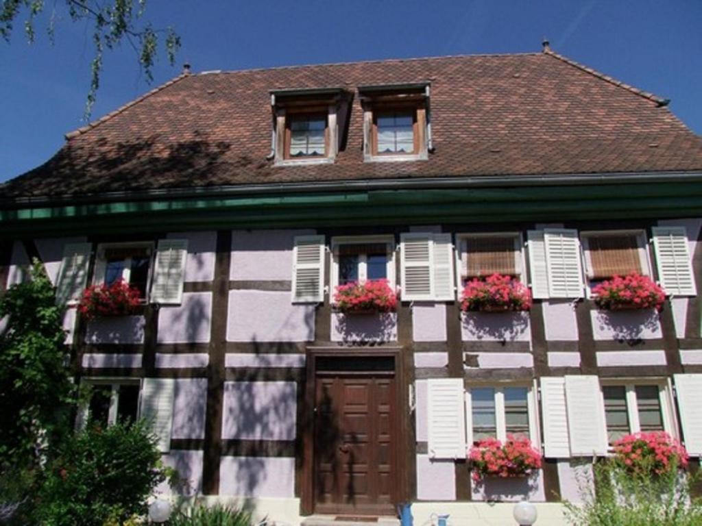 a house with flower boxes on the front of it at Chambres d'hôtes "Aux Portes de l'Alsace" in Suarce