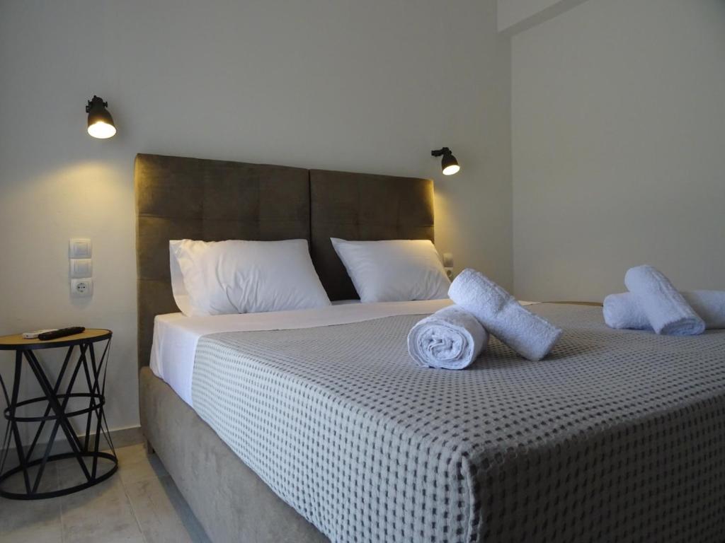 a bedroom with a large bed with two pillows on it at Dimitra Apartments in Kanali