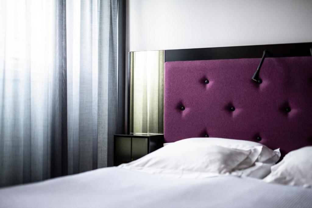 Postel nebo postele na pokoji v ubytování Hotel Flora