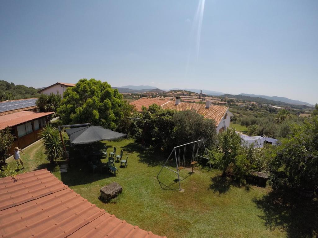 an aerial view of a garden with an umbrella at Agriturismo Su Meurreddu in Tratalias