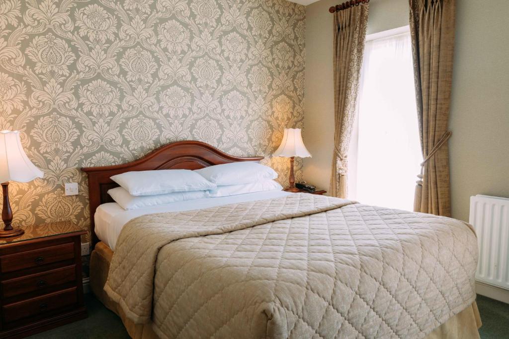 Postel nebo postele na pokoji v ubytování Sheedy's Boutique Hotel
