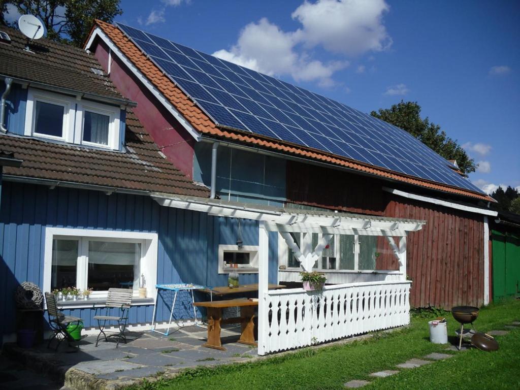 une maison avec des panneaux solaires sur le toit dans l'établissement Ferienhaus Schwärzer, à Bischofsgrün