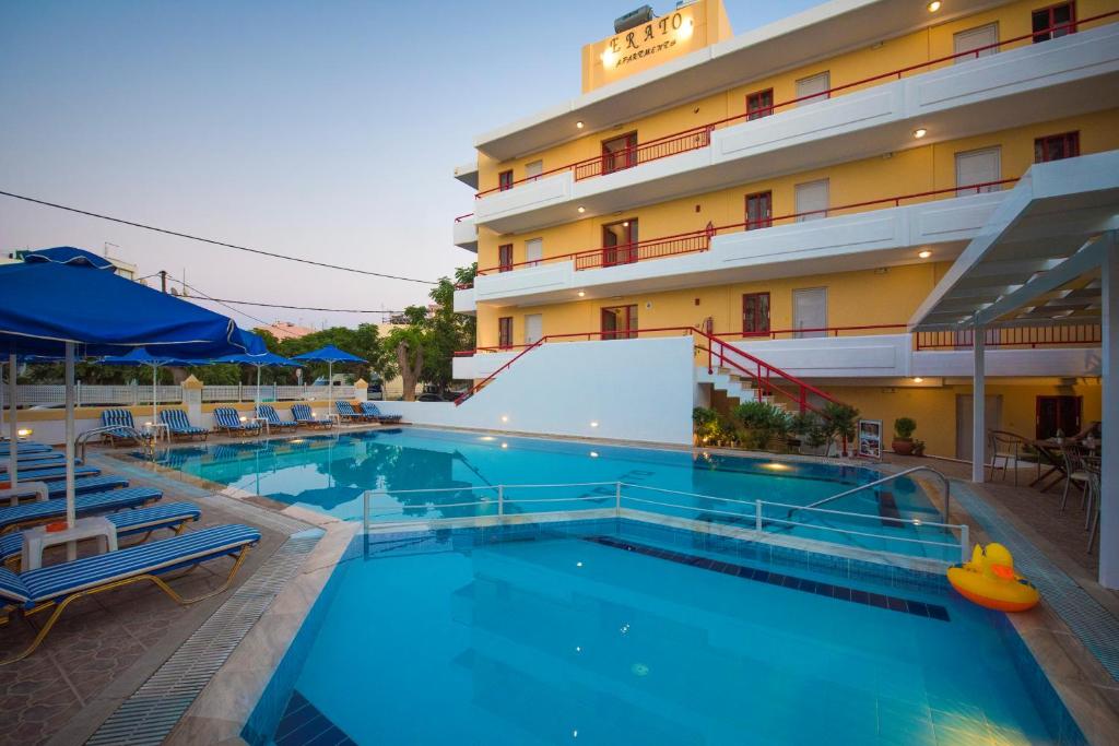 a swimming pool in front of a hotel at Erato Studios & Apartments in Kos