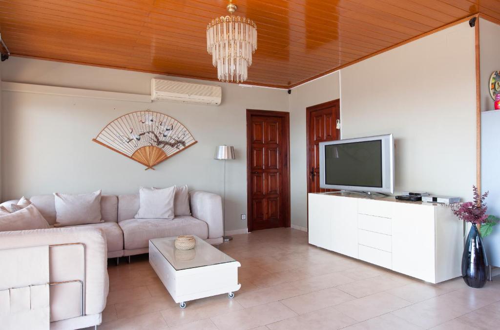 A television and/or entertainment centre at Lets Holidays Apartment Costa Brava
