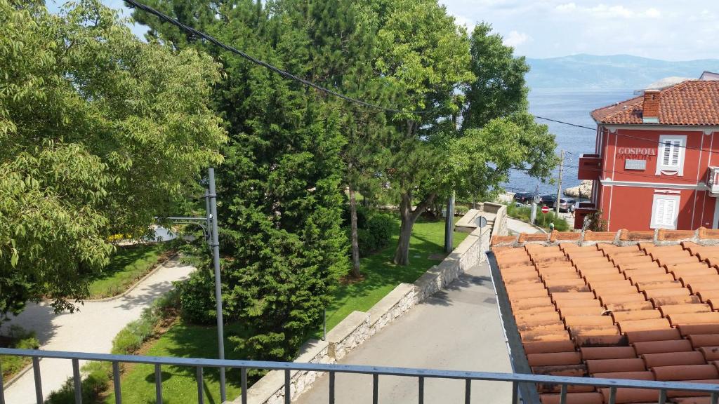 a view from the balcony of a red house at APARTMENT PALAZZO ŠARE in Vrbnik