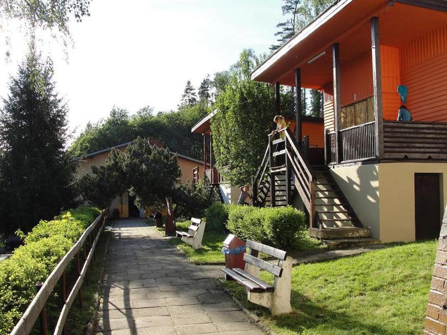 a house with a porch and a walkway next to a building at Niepubliczne Schronisko Młodzieżowe Lubawka in Lubawka