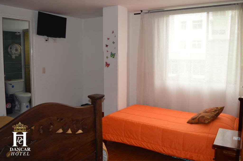 Postel nebo postele na pokoji v ubytování Hotel Dancar