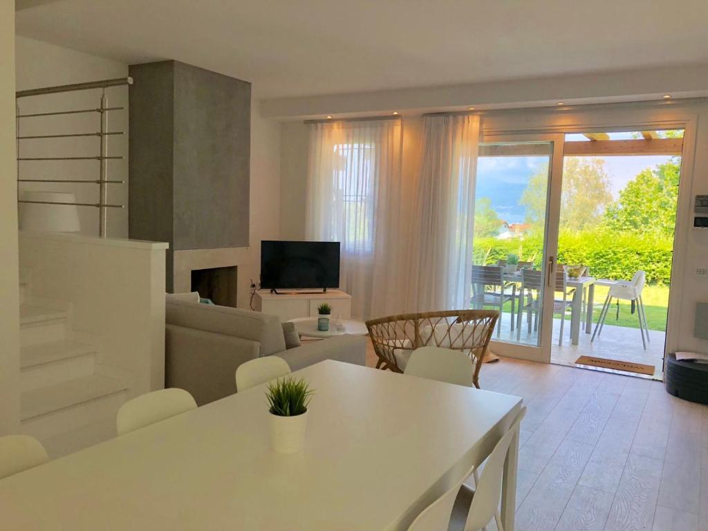 a living room with a couch and a table with chairs at Italia Living Villa in Padenghe sul Garda