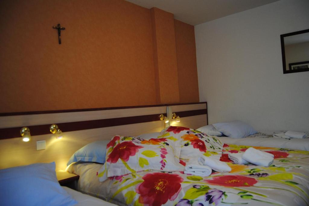 Postel nebo postele na pokoji v ubytování Hôtel Myosotis