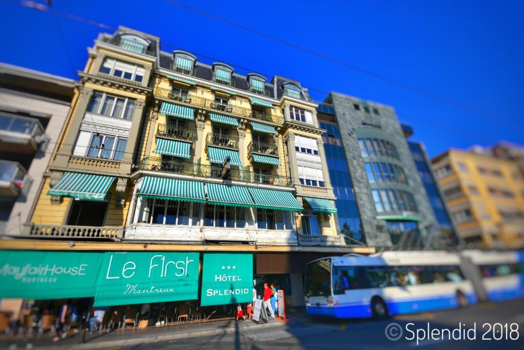 er staat een bus voor een gebouw geparkeerd bij Hotel Splendid in Montreux