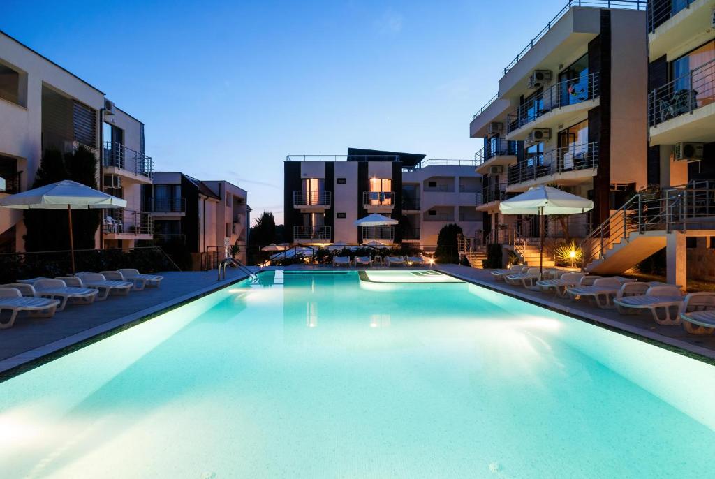 a large swimming pool in the middle of a building at New Line Village Apartments in Sunny Beach