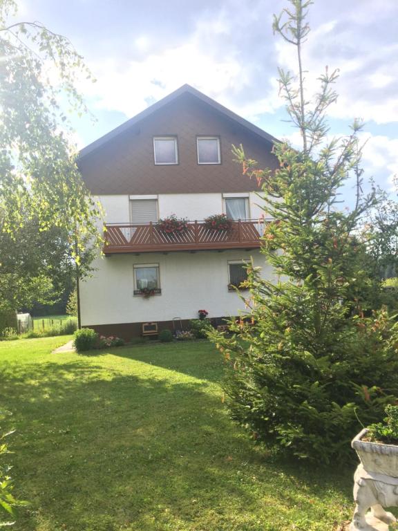 a white house with a red roof at Haus Bergzauber in Eschlkam