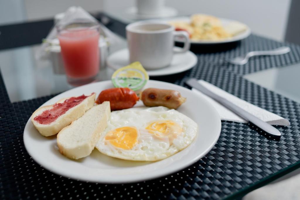 a plate of food with eggs and bread on a table at Hotel Arawak Upar in Valledupar