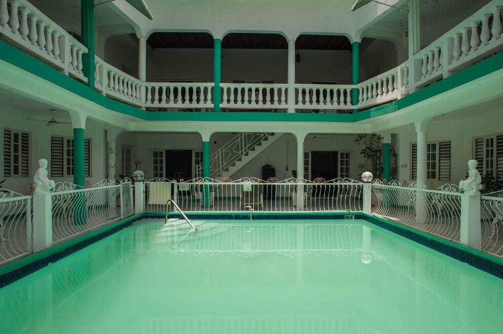 an indoor swimming pool in a building at Diamond Villa Guest House in Montego Bay