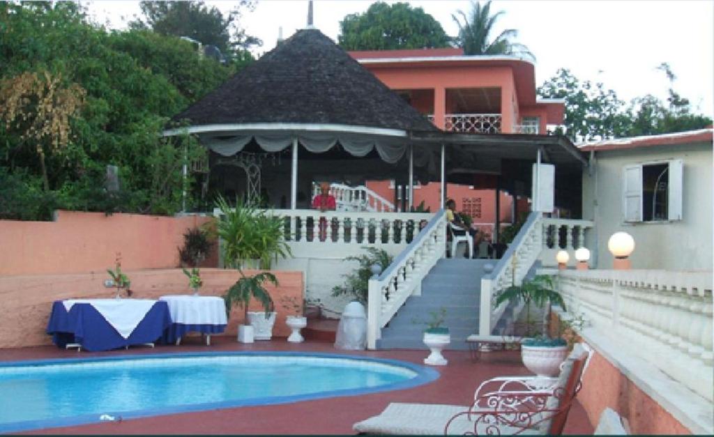 a house with a pool and a gazebo at Verney House Resort in Montego Bay